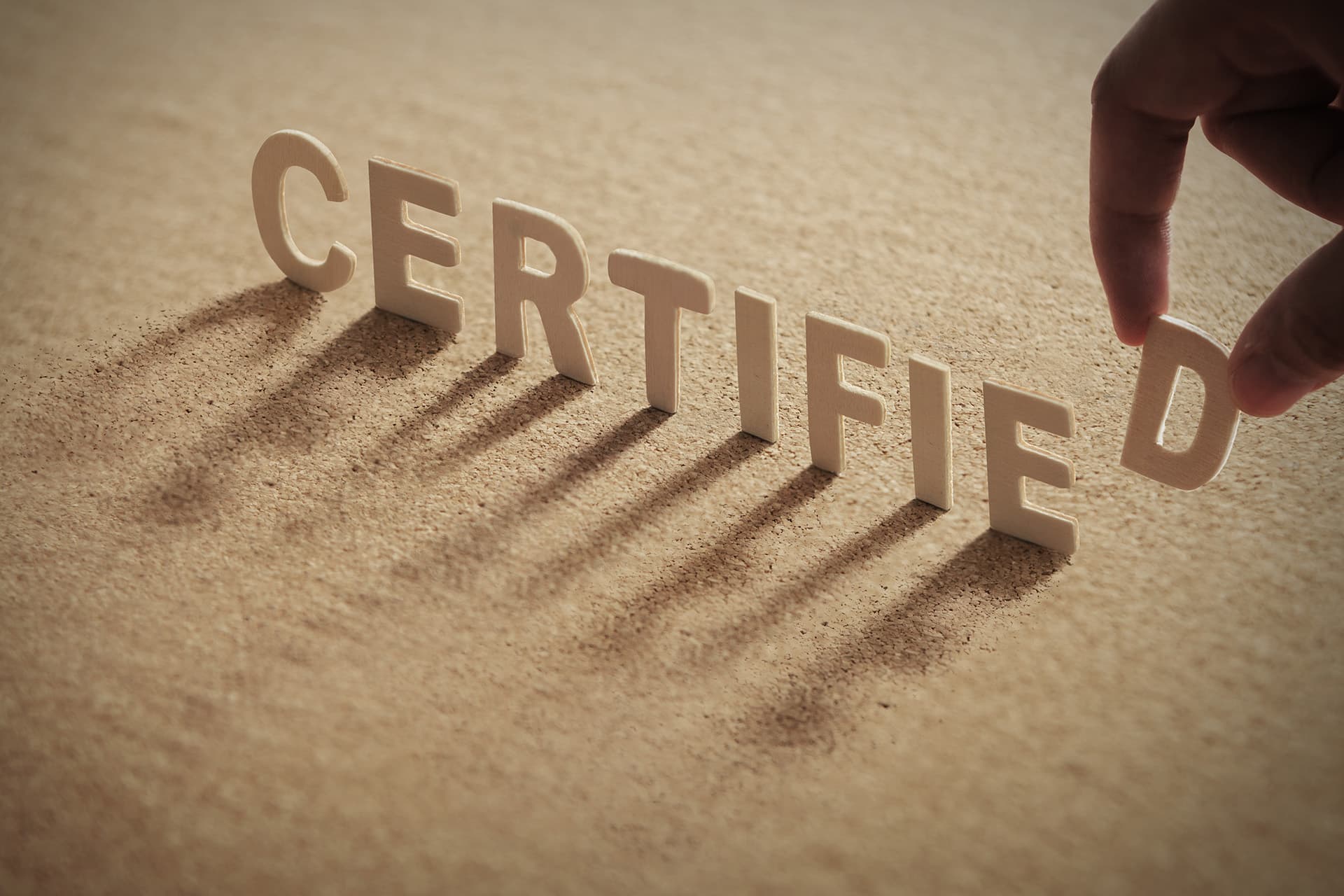 Wooden letters spelling CERTIFIED